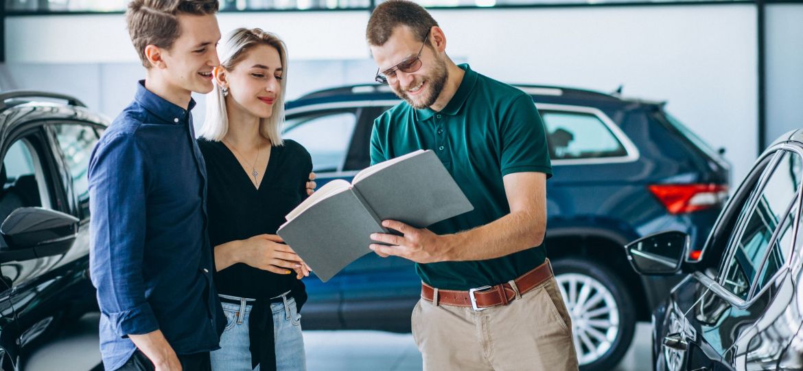 Young family buying a car in a car showroom