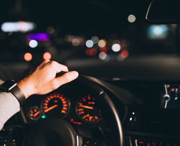 Young man driving his car at a night time